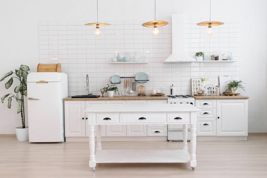A bright, minimalist kitchen with vintage appliances, plants, and pendant lights.