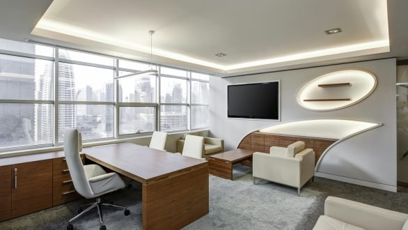 Sleek office space featuring contemporary furniture and city skyline views, ideal for professionals.